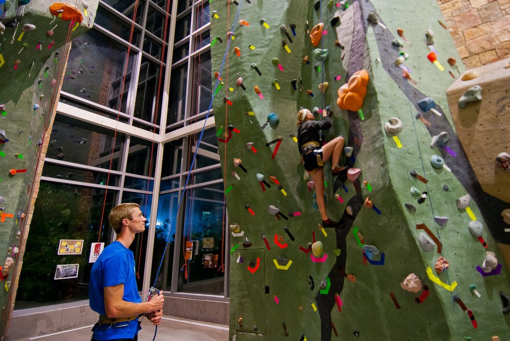 People climbing the rock climbing wall in the SSU Rec Center