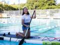 Student paddle boarding in the pool 