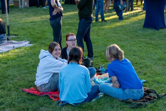 A group sits together on the lawn