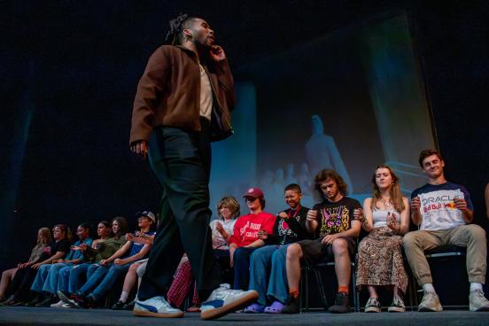 Man walks across a stage