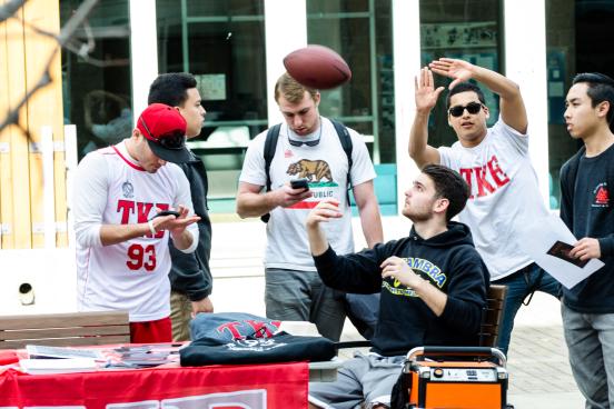 Group hangs out throwing football around