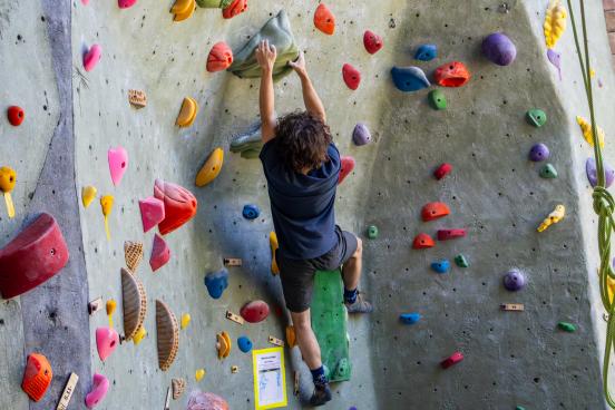Student climbs rec center rock wall