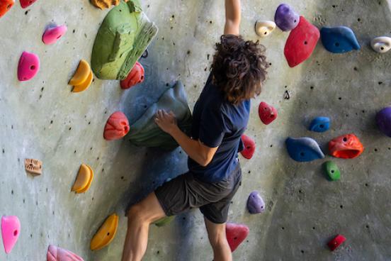 Person climbing on rock wall