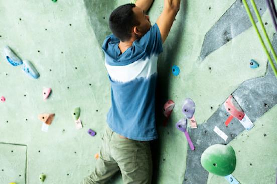 Person climbing on rock wall
