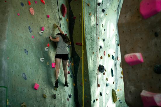 Student climbs rec center rock wall
