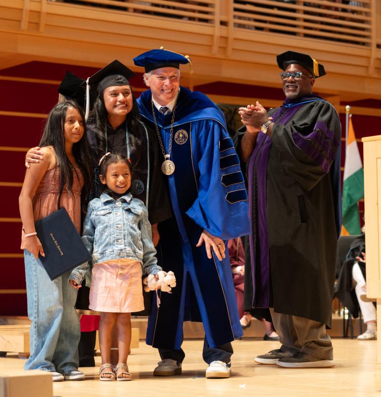 Graduate with family walking the stage