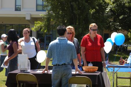 People tabling at an outdoor fair at SSU