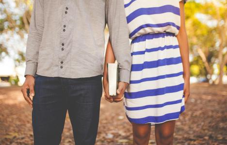 Two people holding hands