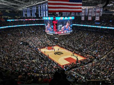An indoor basketball arena with people in the stands