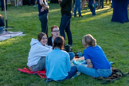 A group sits together on the lawn