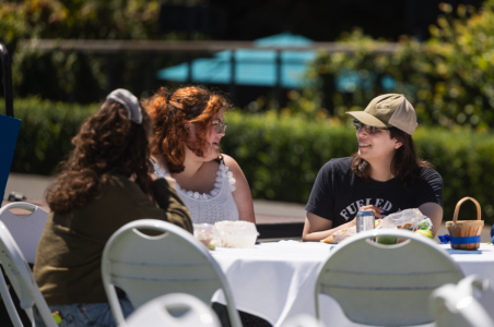 A group sits together with food and drinks