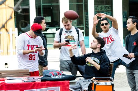 Group hangs out throwing football around