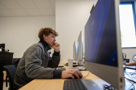Student typing on a computer