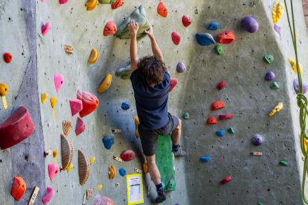 Student climbs rec center rock wall