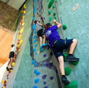 Student climbs rec center rock wall