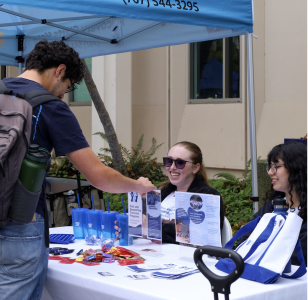 Student talks under an info tent