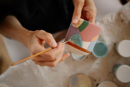 Someone painting a mug