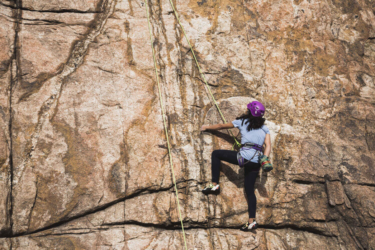 Person doing  outdoor rock climbing 