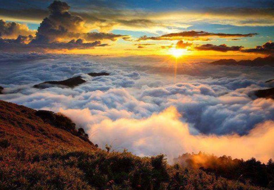 Colorful clouds rolling over hills during sunset or sunrise 