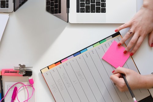 A student writing in a planner