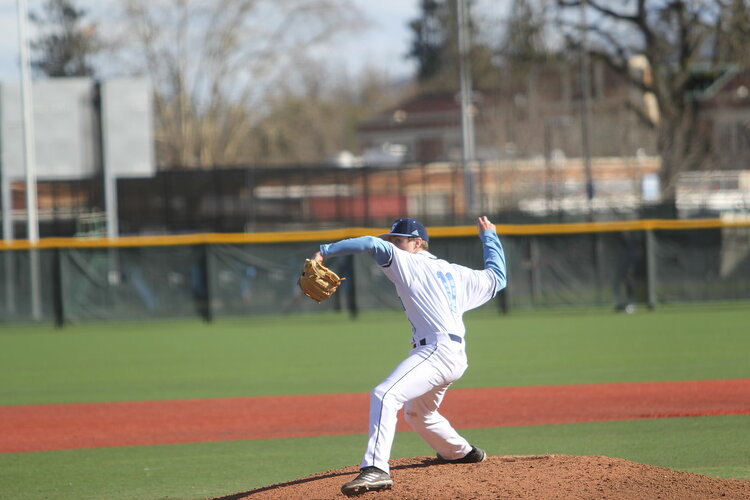 Student pitching a baseball 