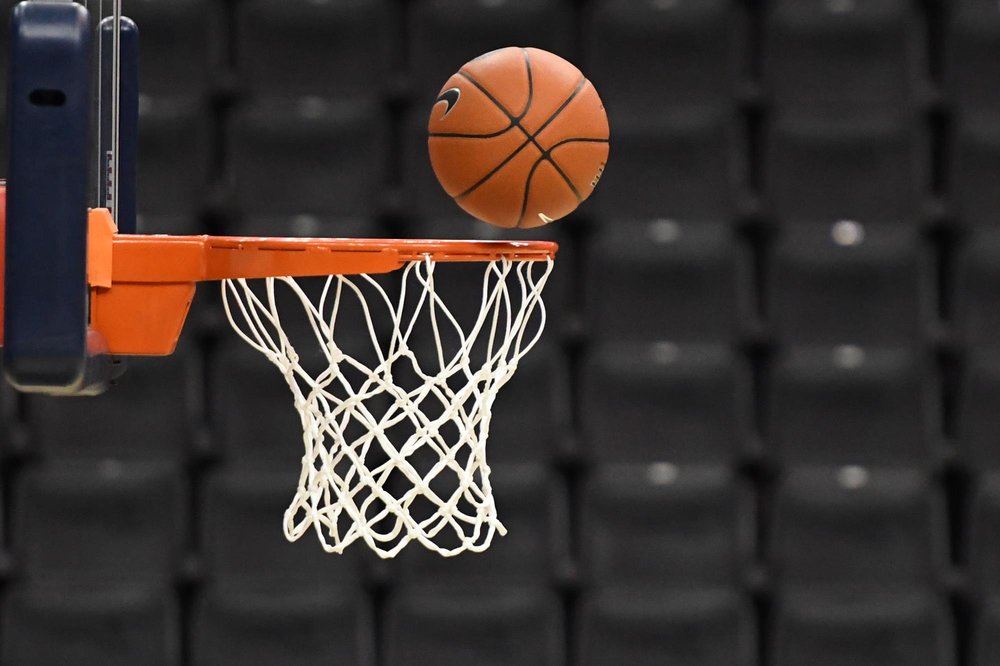 a basketball going into a basketball hoop