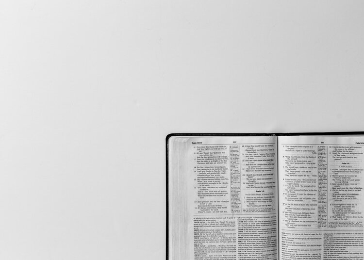 An open bible in front of a white background