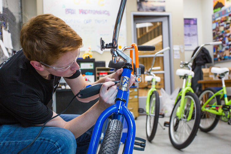 Student fixing a bike