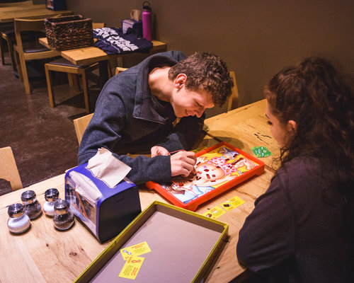 Students playing a board game 