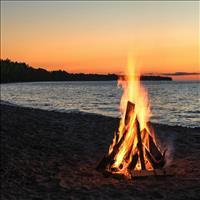A bonfire burning on a beach