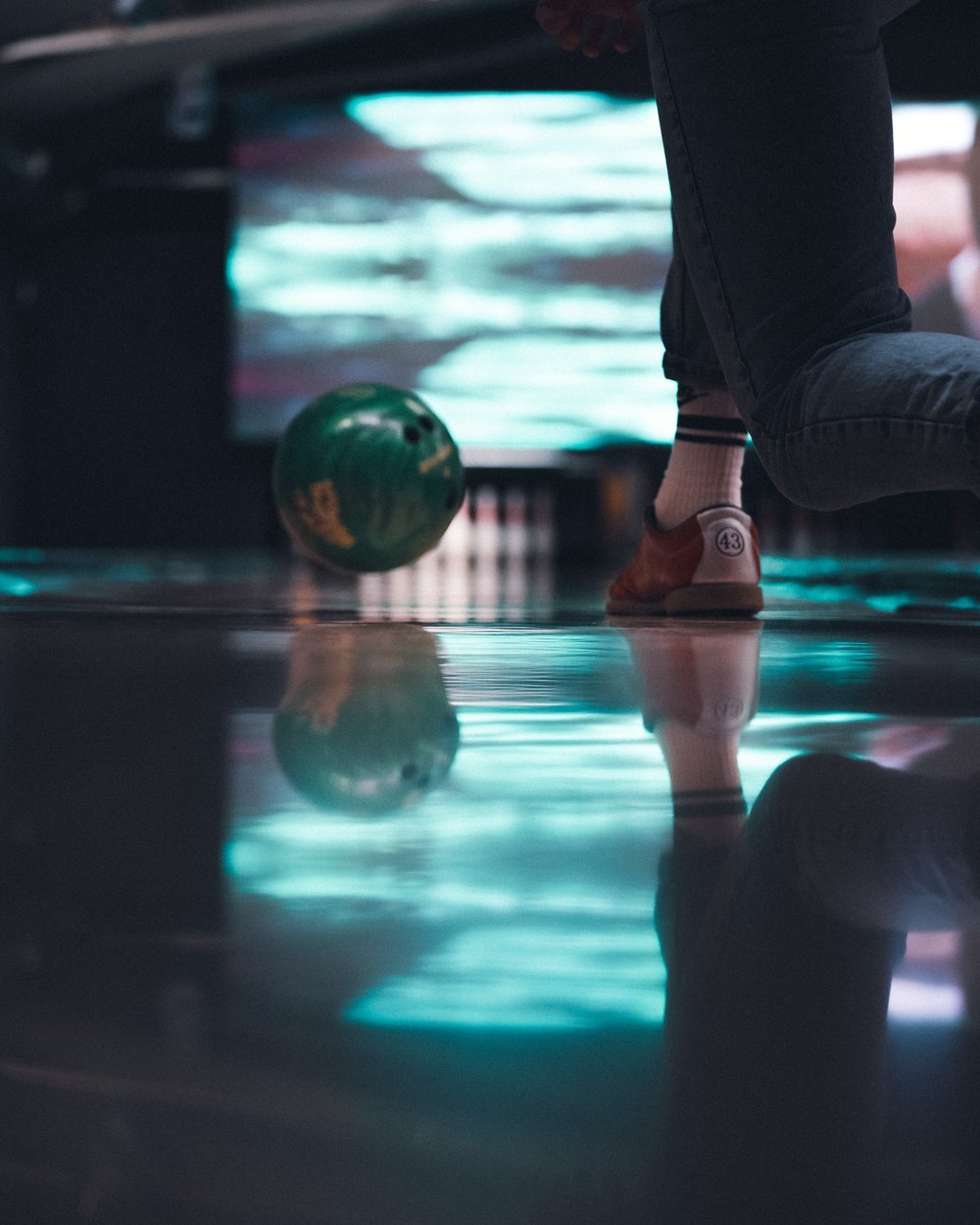a bowling ball being thrown in a bowling alley