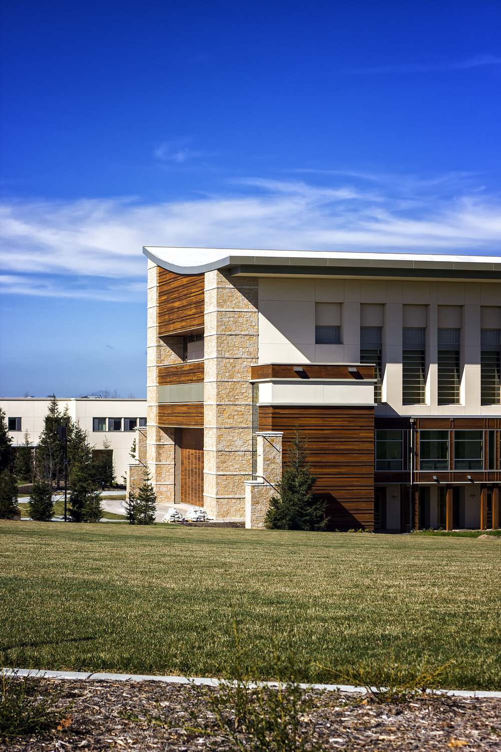 A view of the exterior of the Green Music Center on a sunny day with green grass in the foreground and blue skies in the background