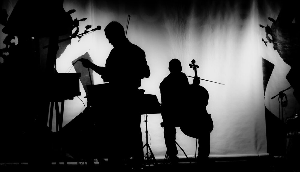 the silhouettes of people playing instruments