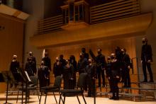 People singing on stage at a choir concert performance