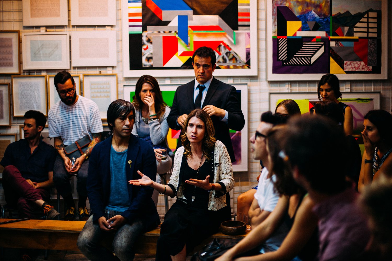 Members of a club sitting in and indoor setting and having a discussion