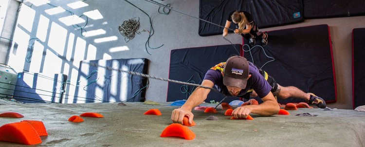 A person indoor rock climbing 