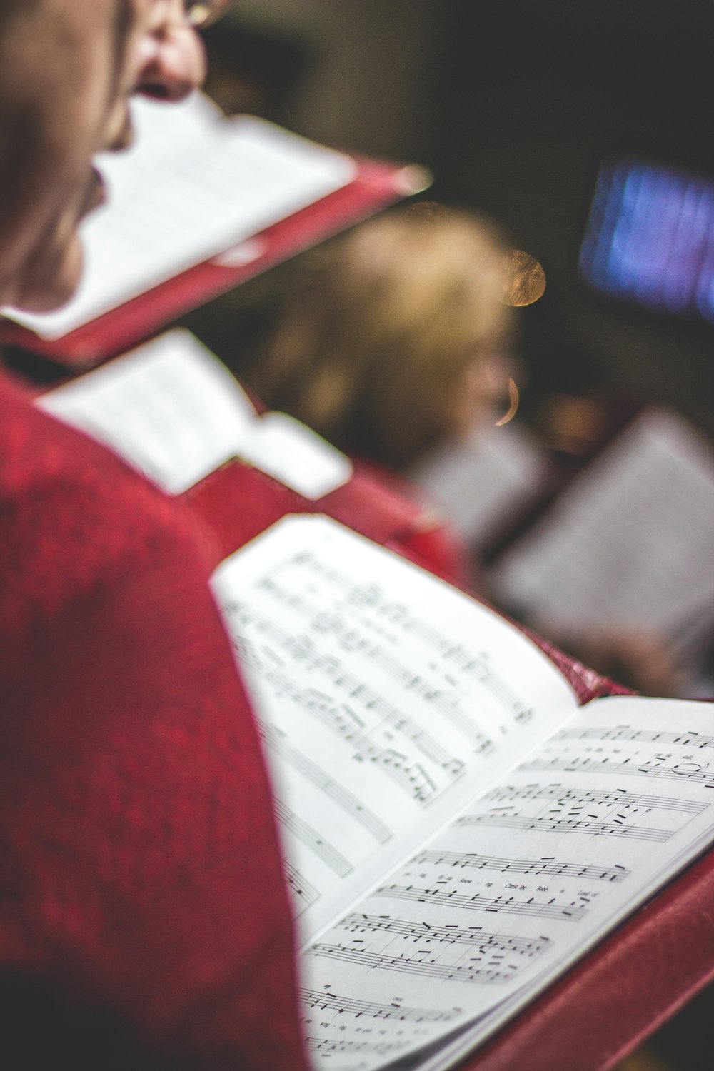 a choir person reading sheet music