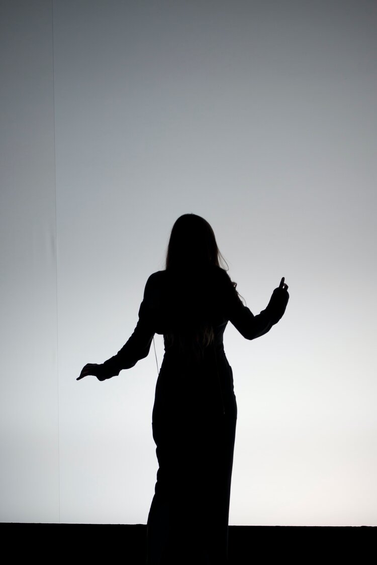 Black and white photo of the silhouette of someone dancing 