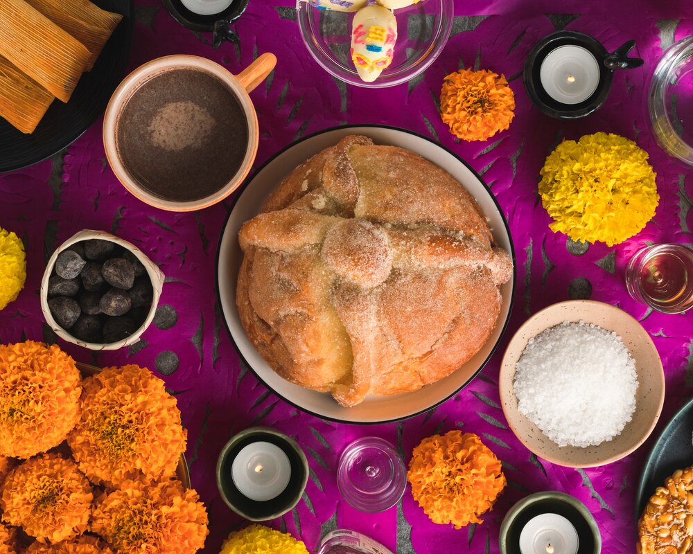 various items involved in Día de los Muertos laid on a table