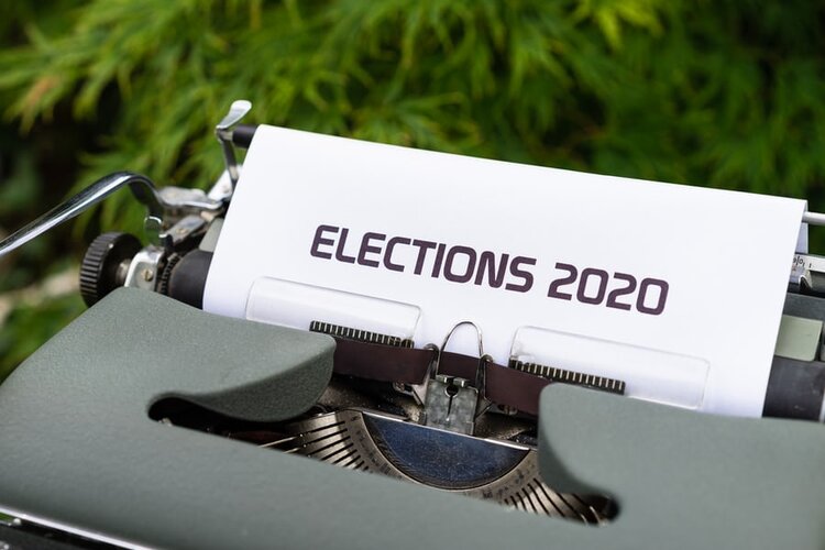 A grey typewriter with paper with text on it that reads "Elections 2020"