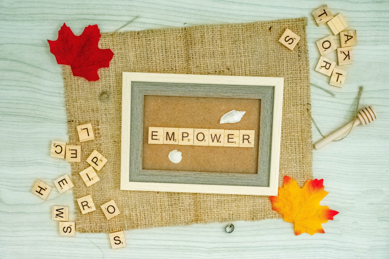 The word 'Empower' spelled with scrabble pieces 