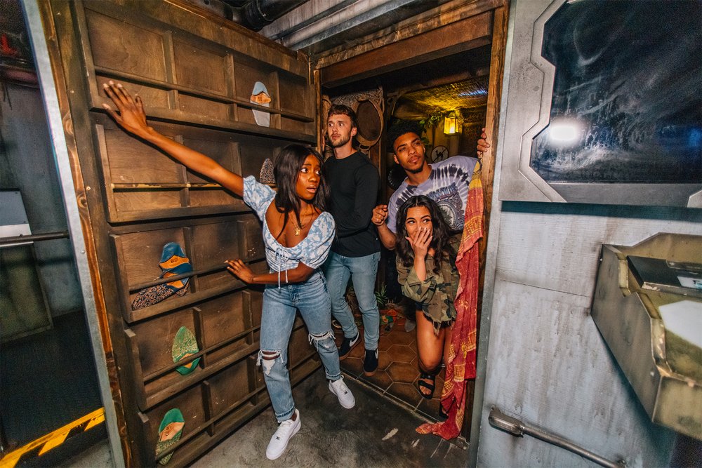 Four people opening the door of an escape room