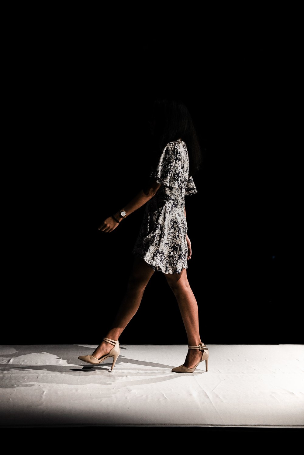 a person walking down a fashion runway