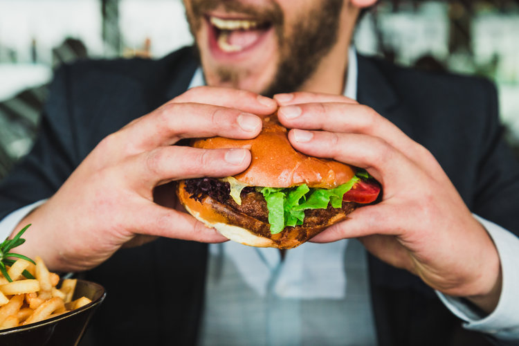 Person holding a burger