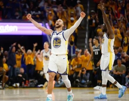 a player from the Golden State Warriors basketball team cheering on the basketball court