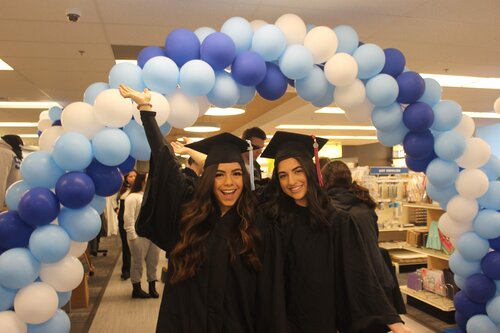 Students at the grad fair in cap and gown 