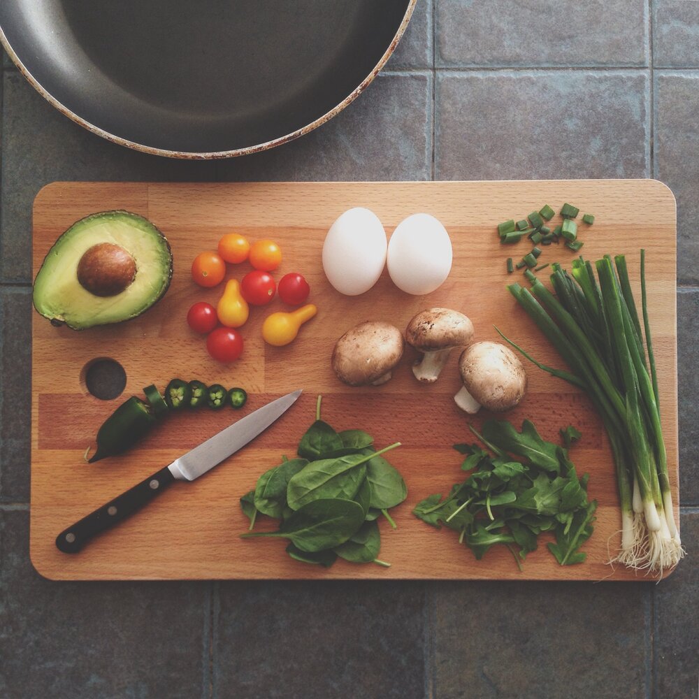 A variety of colorful vegetables on a wooden cutting board