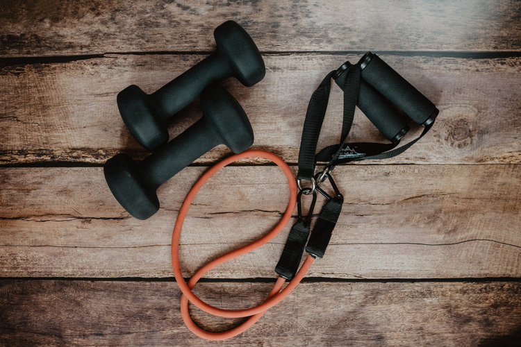 Black and orange workout equipment on top of wood slats