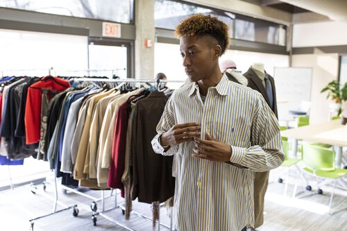 Student trying on business clothes