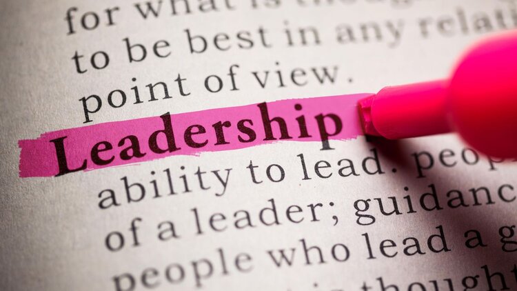 A pink highlighter pen highlighting the word "Leadership" on a page full of words